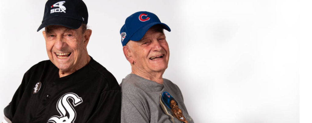 nick and lou wearing cubs and sox jersey back to back